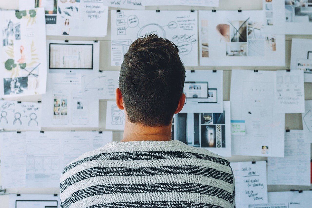 a man looking at a white board
